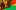 A graffiti inspired graphic image, red, green and yellow in colour. In the top centre is Jonzi D, a Black man and the Artistic Director of Breakin' Convention. To the left of him are smaller images of different hip-hop dancers, posing strong and dynamically.