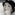 A closeup of Alina Cojocaru in clown makeup and a bowler hat