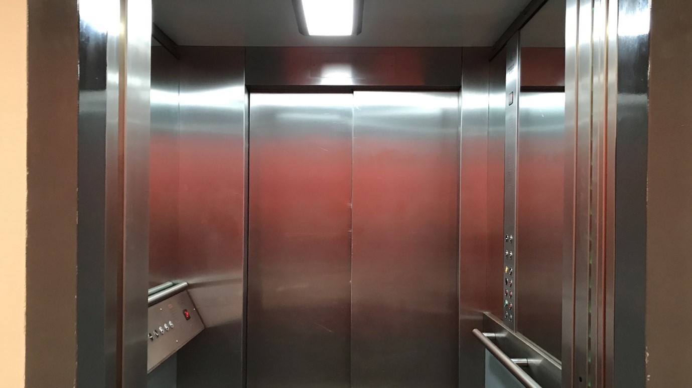 The silver interior of a lift at Sadler's Wells Theatre