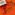 A cassette tape lies on an orange surface. It’s labelled ZOONATION MIXTAPE. A tangle of shiny brown tape pulled from the cassette has been formed into the outline of a cartoon figure with spiky hair, hands raised, fingers spread and eyes wide.